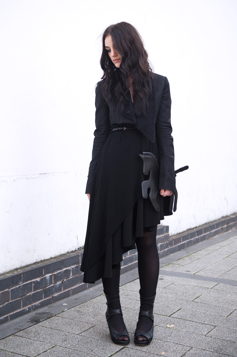 Fashion blogger Stephanie of FAIIINT wearing Choies black unicorn clutch bag, Todd Lynn for Topshop cropped Tux Jacket, Topshop Asymmetric top, A Wear skirt, Rick Owens wedges, ONecklace name necklace. All black, goth, dark, street style.