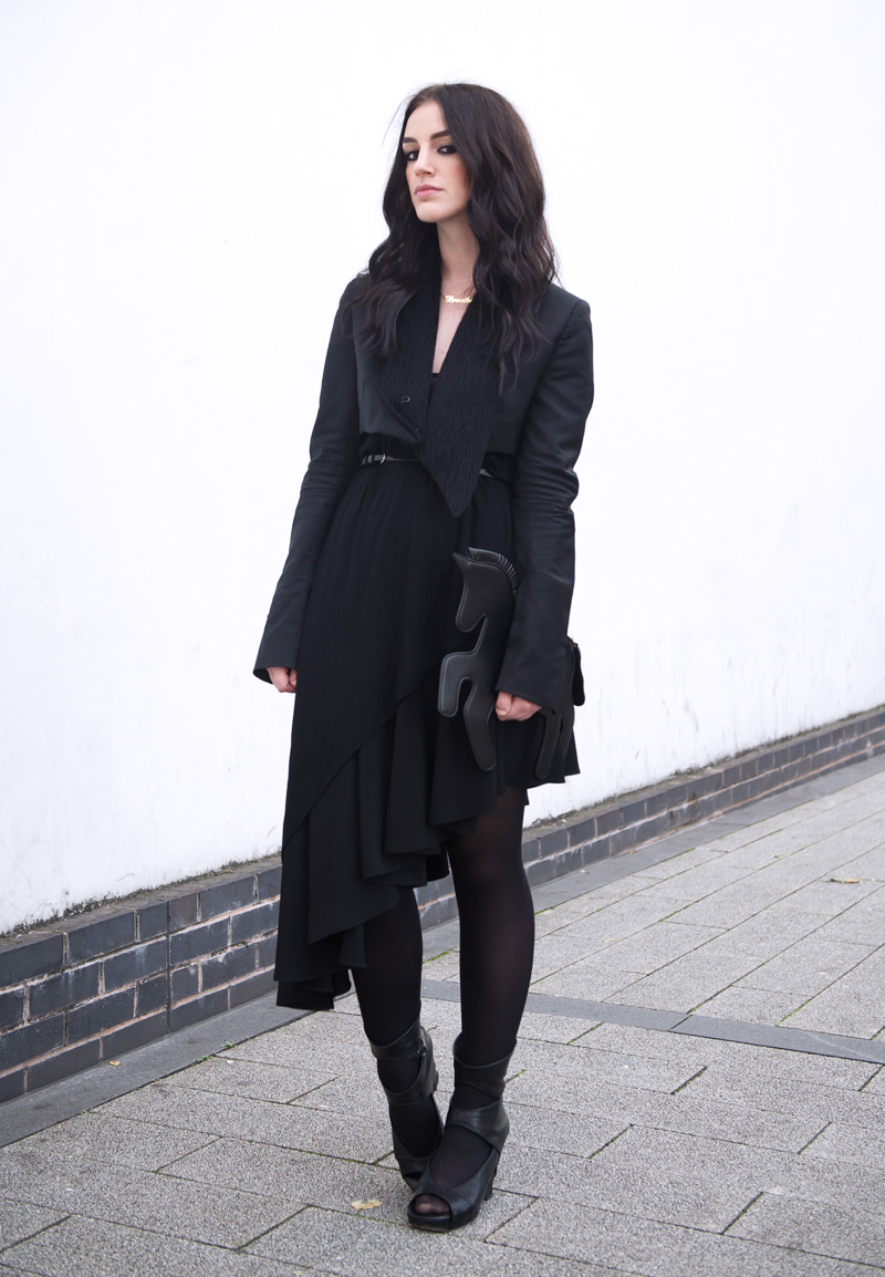 Fashion blogger Stephanie of FAIIINT wearing Choies black unicorn clutch bag, Todd Lynn for Topshop cropped Tux Jacket, Topshop Asymmetric top, A Wear skirt, Rick Owens wedges, ONecklace name necklace. All black, goth, dark, street style.