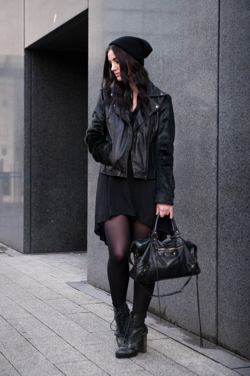 Fashion blogger Stephanie of FAIIINT wearing Black.co.uk cashmere slouch beanie, ASOS leather & faux fur biker jacket, MeeMee dip hem dress, Topshop lace up boots, Balenciaga city. All black outfit, street style, grunge, goth, casual.