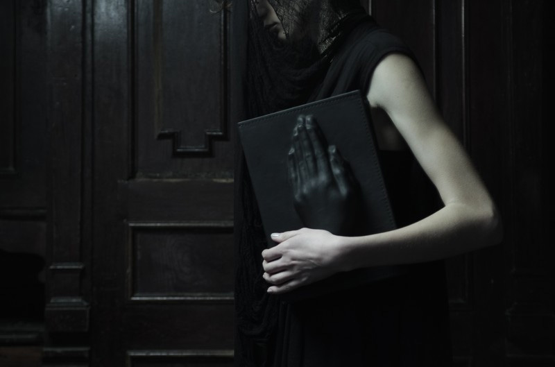 Konstantin Kofta 'Hug' collection book praying hands black leather clutch. Dark style, gothic, indepenent designer, lookbook