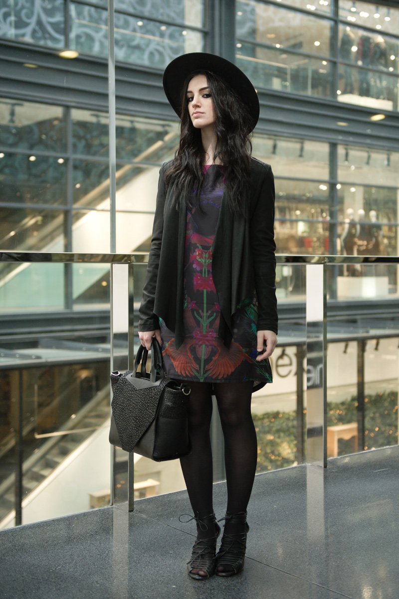Fashion blogger Stephanie of FAIIINT wearing Barneys Originals drape leather jacket, Yumi midnight menagerie bird & floral print dress, Bracher Emden classic tote bag, Skin by Finsk lace up wedges, Catarzi fedora, all black outfit, gothic, street style.