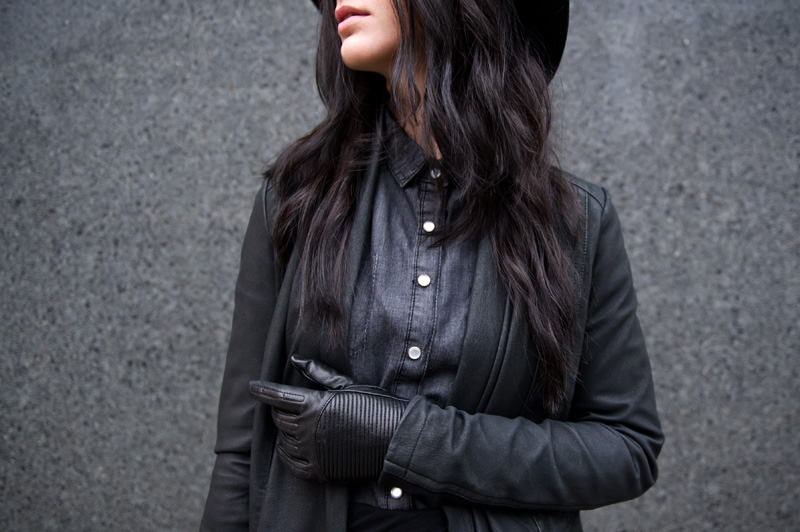 fashion blogger Stephanie of FAIIINT wearing Catarzi fedora, Barneys Originals draped leather jacket, Chiara fashion denim shirt, River Island asymmetric skirt, Rick Owens wedges, Balenciaga city. Dark fashion, all black outfit, tailored, androgynous.