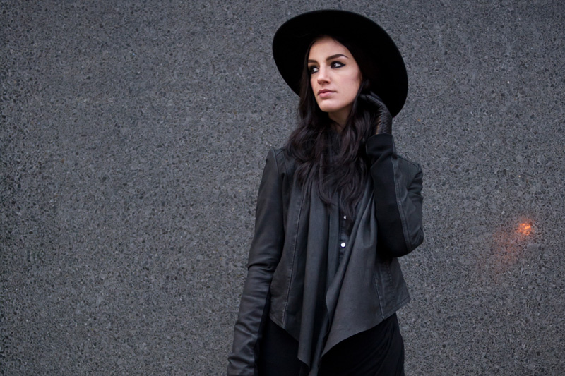 fashion blogger Stephanie of FAIIINT wearing Catarzi fedora, Barneys Originals draped leather jacket, Chiara fashion denim shirt, River Island asymmetric skirt, Rick Owens wedges, Balenciaga city. Dark fashion, all black outfit, tailored, androgynous.