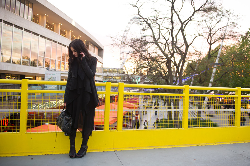 Fashion blogger Stephanie of FAIIINT wearing Todd Lynn for Topshop Cropped Tux Jacket with fur collar, ASOS waterfall draped cardigan, Warehouse chiffon dress, Rick Owens Wedges, Balenciaga City Bag. All black outfit, london, tourist, eye, dark style, goth outfit.