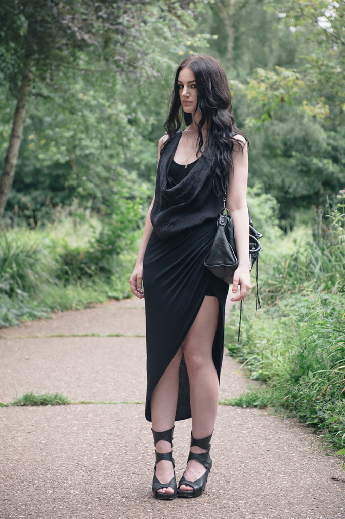 Fashion blogger Stephanie of FAIIINT wearing FOX via Log On Style draped silk tank top, River Island asymmetric skirt, YoungHearts designs gold dipped quartz necklace, Rick Owens wedges, Balenciaga city bag. All black goth summer street style outfit.