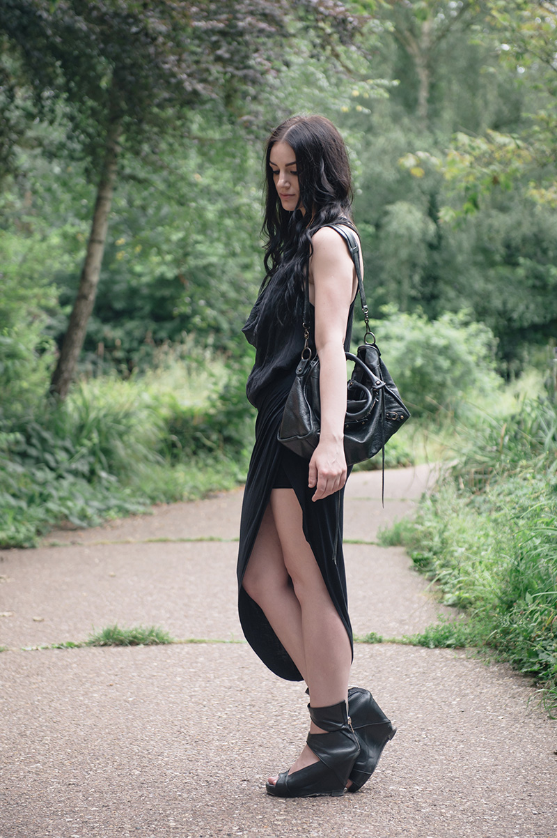 Fashion blogger Stephanie of FAIIINT wearing FOX via Log On Style draped silk tank top, River Island asymmetric skirt, YoungHearts designs gold dipped quartz necklace, Rick Owens wedges, Balenciaga city bag. All black goth summer street style outfit.