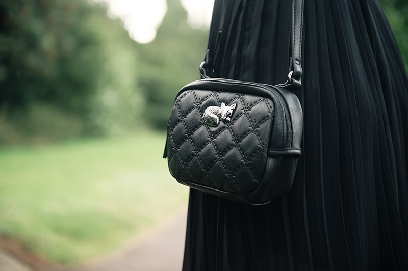 FAIIINT wearin Nica black quilted cross body Pheobe bag with silver sleeping fox hardware