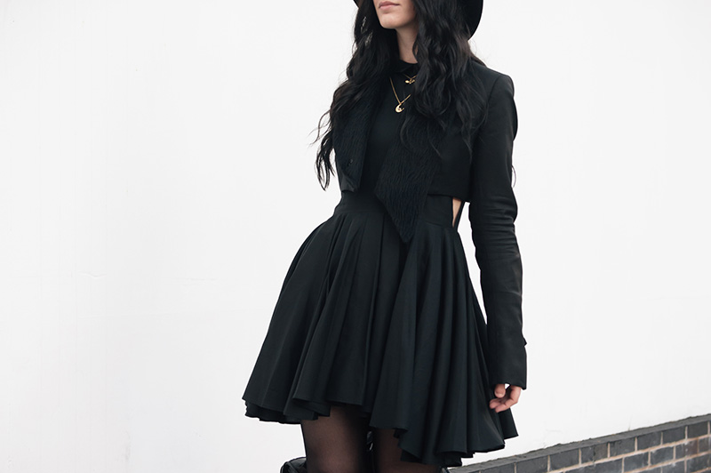 Fashion blogger Stephanie of FAIIINT wearing Todd Lynn x Topshop cropped tux jacket, H&M shirt dress, Phoebe Jewellery moonstone moon & little bat gold necklace, Skin by Finsk laced wedges, Balenciaga city bag, Catarzi fedora. All black witchy street style outfit.