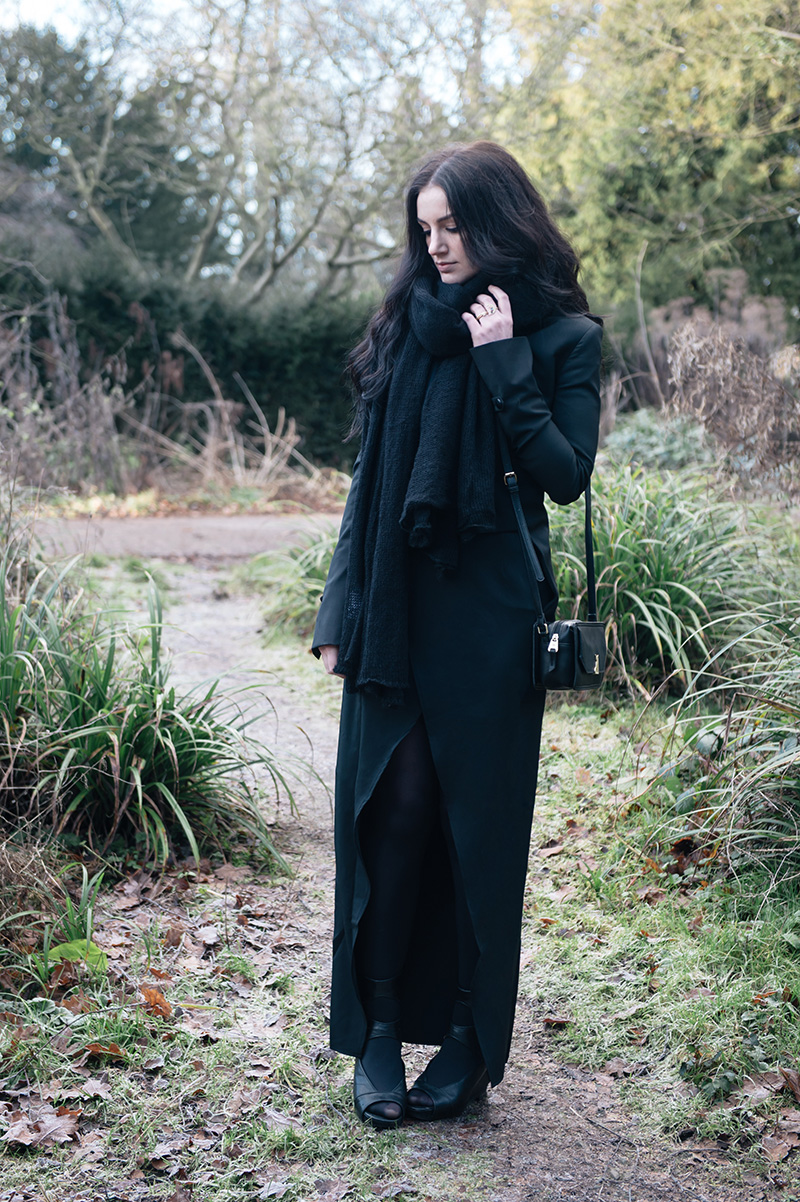 Fashion blogger Stephanie of FAIIINT wearing ASOS oversized scarf, Todd Lynn x Topshop Tux Jacket, State of Being cross over maxi skirt, Nica Venice small crossbody bag, Phoebe Jewellery moonstone moon & star double ring, Rick Owens wedge sandals. All black street style gothic draped outfit.