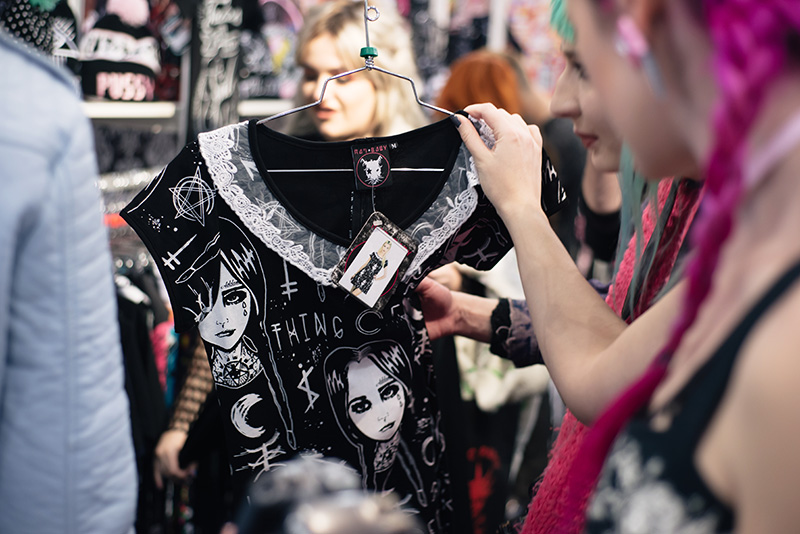 FAIIINT fashion blogger meet up event at London Edge 2015 Olympia Exhibition Centre. RatBaby clothing stall, bloggers looking at Wednesday Addams dress.
