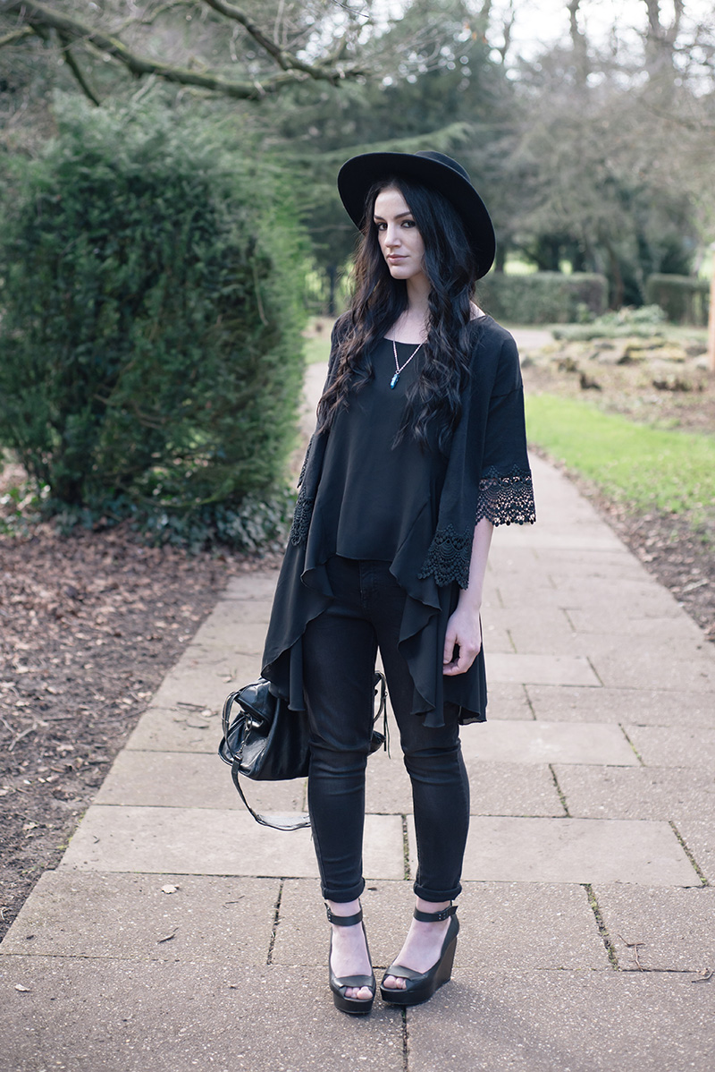 Fashion blogger Stephanie of FAIIINT wearing Dorothy Perkins style heroes soft throw on & girlfriend jean, lace trimmed cropped kimono, washe black skinny jeans, Catarzi fedora, Love drape side tee top, Sightstone aqua aura quartz necklace, Skin by Finsk wedges, Balenciaga city bag. All black street style gothic spring outfit.