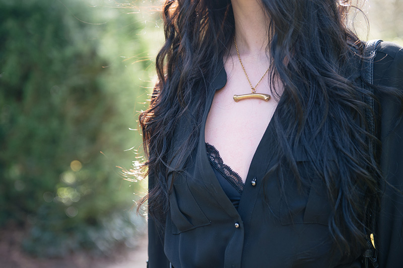 Stephanie of FAIIINT wearing F&F utility black chiffon jumpsuit, Bluebella satin & lace triangle bra peeking out, Sara Gunn horizontal gold bone necklace. Outfit details.