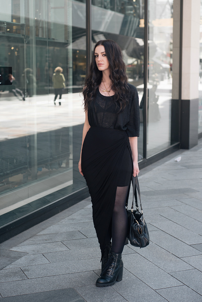 Fashion blogger Stephanie of FAIIINT wearing Cyeoms virtual asymmetric tee, FAIIINT swathe draped skirt, Sara Gunn bone necklace, Ash poker Boots, Mulberry Mabel bag. Casual all black goth street style outfit.
