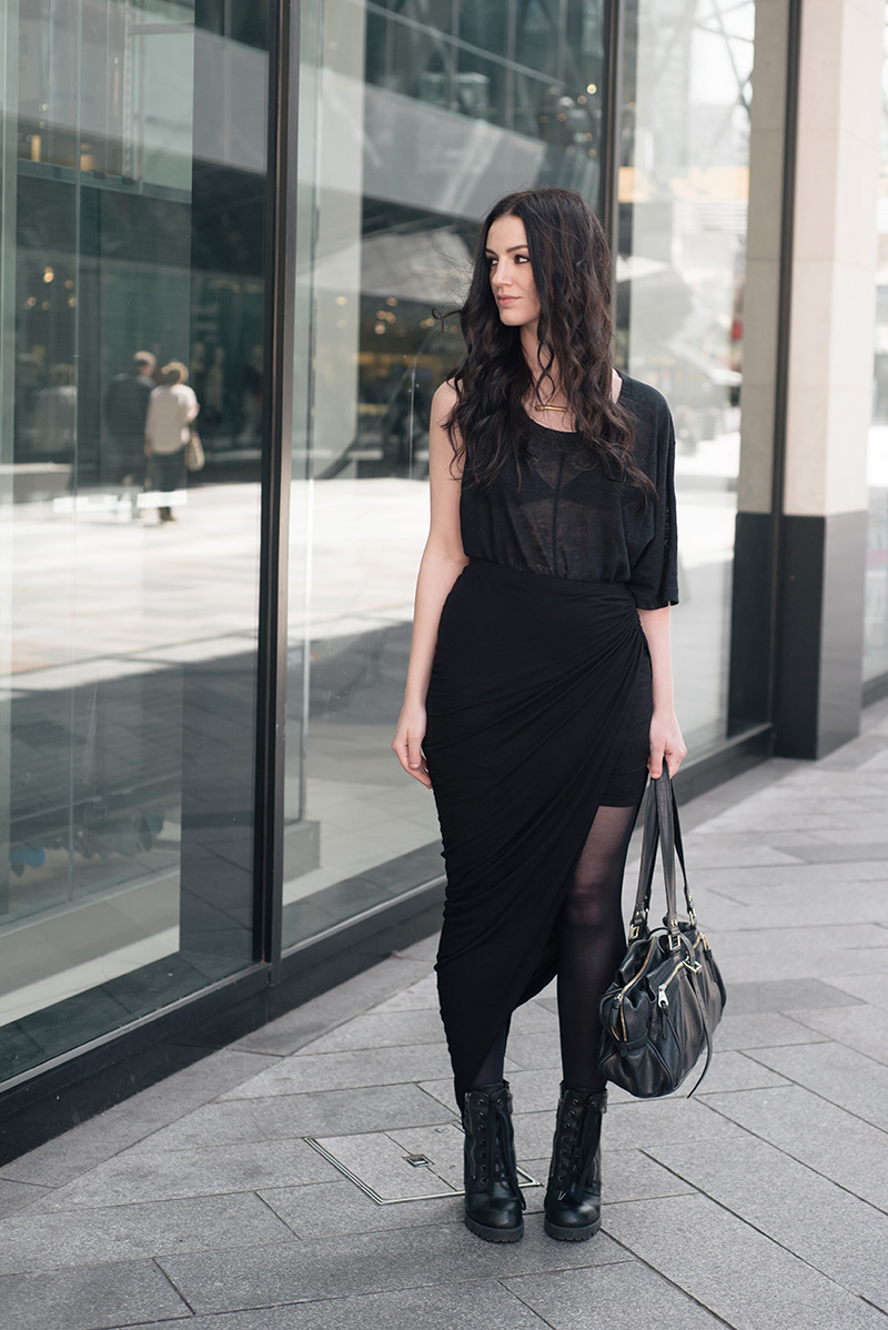 Fashion blogger Stephanie of FAIIINT wearing Cyeoms virtual asymmetric tee, FAIIINT swathe draped skirt, Sara Gunn bone necklace, Ash poker Boots, Mulberry Mabel bag. Casual all black goth street style outfit.