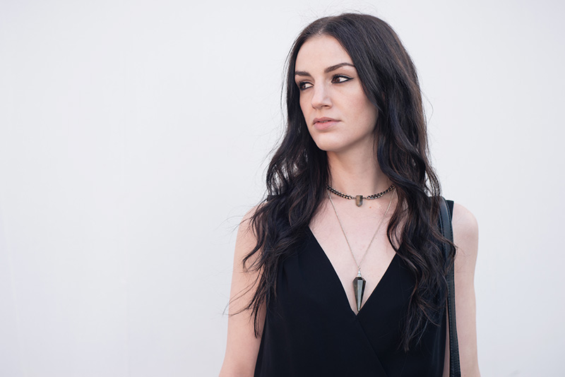 Fashion blogger Stephanie of FAIIINT wearing Warehouse chiffon wrap dress, Regal Rose Rua gemstone point choker, Regal Rose Cosmos Labradorite crystal pendulum necklace. Portrait details.