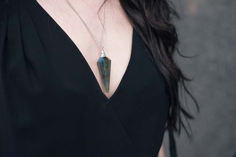Fashion blogger Stephanie of FAIIINT wearing Warehouse chiffon wrap dress, Regal Rose Cosmos Labradorite crystal pendulum necklace.