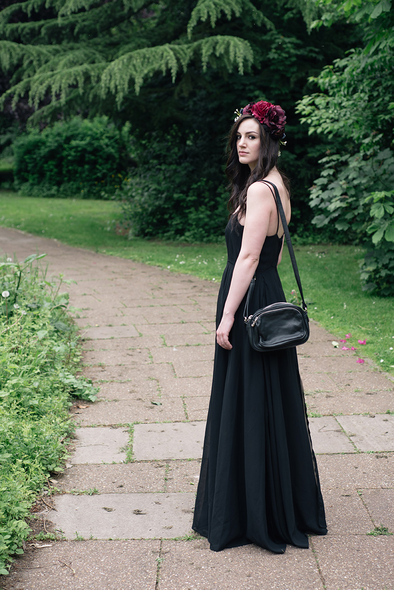 Fashion blogger Stephanie of FAIIINT wearing Gypsy Rose Vintage plum & pink flower crown, Religion Olsen Maxi dress. All black gothic summer wedding guest outfit. Dark style.