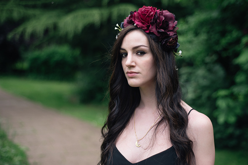 Fashion blogger Stephanie of FAIIINT wearing Gypsy Rose Vintage plum, pink & black flower crown with roses, peonies & white gypsophila wild flowers, Phoebe Jewellery moonstone moon gold necklace. Portrait, details.