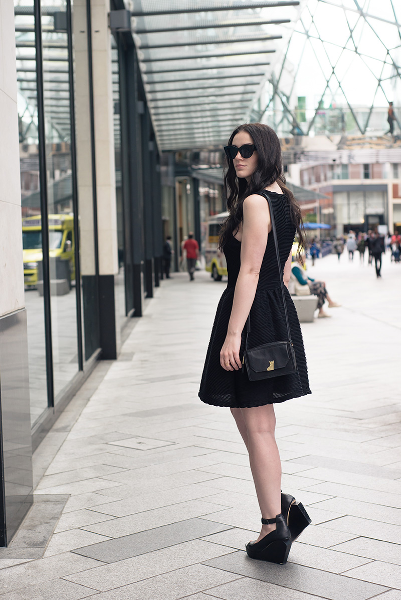 Fashion blogger Stephanie of FAIIINT wearing ASOS cateye sunglasses, Topshop textured skater dress, Nica Venice crossbody bag, Skin by Finsk wedges, Skin by Nair. Casual summer all black street style outfit.
