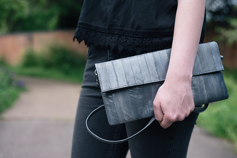 Fashion blogger Stephanie of FAIIINT wearing Makki elephant grey Nuevo Disco eel skin panel clutch bag.