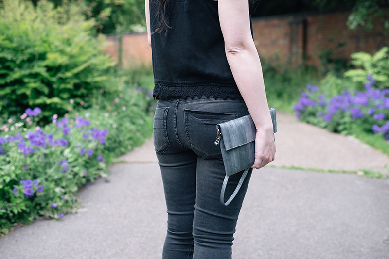 Fashion blogger Stephanie of FAIIINT wearing New Look crochet lace hem crop top, Label Lab washed black high waist jeans, Makki elephant grey Nuevo Disco eel skin clutch bag. Details.