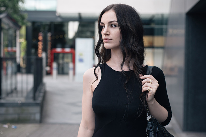 Fashion blogger Stephanie of FAIIINT wearing FAIIINT asymmetric slash one sleeve jersey dress, Balenciaga City bag, A Weathered Penny brass rings. All black everything street style summer goth outfit.