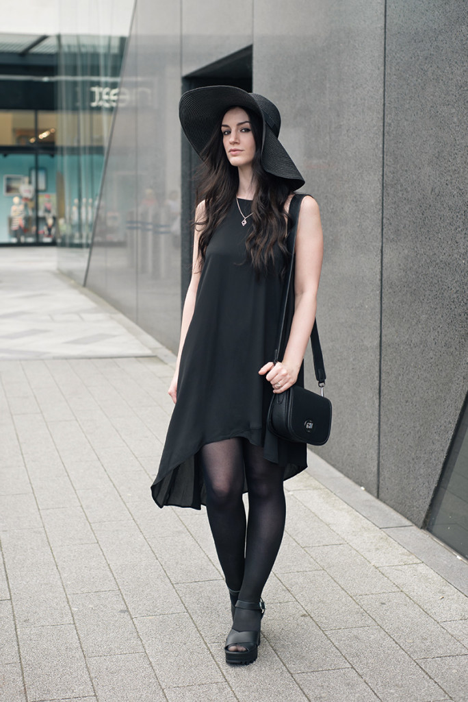 Fashion blogger Stephanie of FAIIINT wearing New Look black floppy strap hat, asymmetric cami dress & cleated platform sandals, Marc B Baby Bianca bag, Bloody Mary Metal tribal moon necklace & stack rings. All black everything street style summer goth outfit.