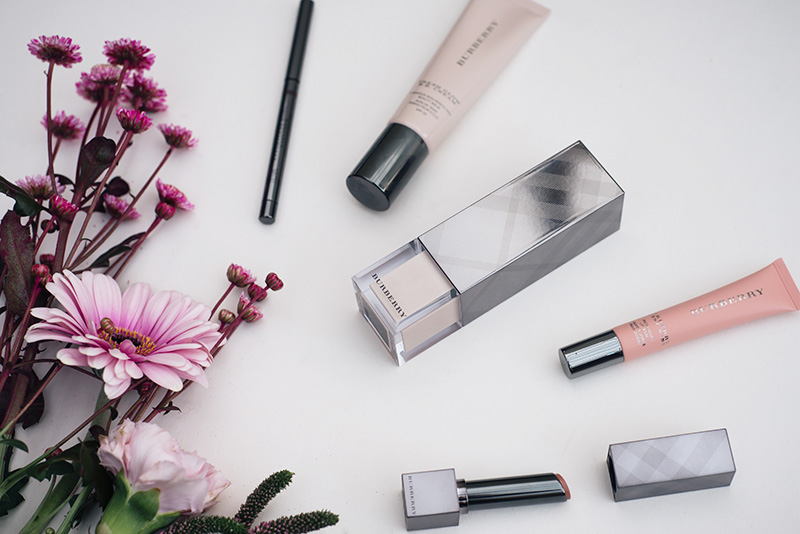FAIIINT Burberry Beauty. Fresh Glow Luminous Fluid Base in No. 01 Nude Radiance, Fresh Glow B.B. Cream in No. 02 Medium, First Kiss Lip Gloss Balm in No. 01 Soft Peach, Kisses Sheer Lipstick in No. 201 Nude Beige, Effortless Kohl Eyeliner in No. 02 Chestnut Brown.