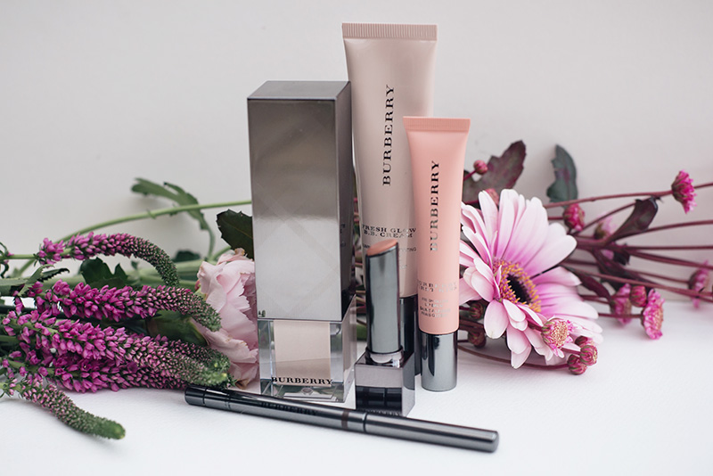FAIIINT Burberry Beauty. Fresh Glow Luminous Fluid Base in No. 01 Nude Radiance, Fresh Glow B.B. Cream in No. 02 Medium, First Kiss Lip Gloss Balm in No. 01 Soft Peach, Kisses Sheer Lipstick in No. 201 Nude Beige, Effortless Kohl Eyeliner in No. 02 Chestnut Brown.