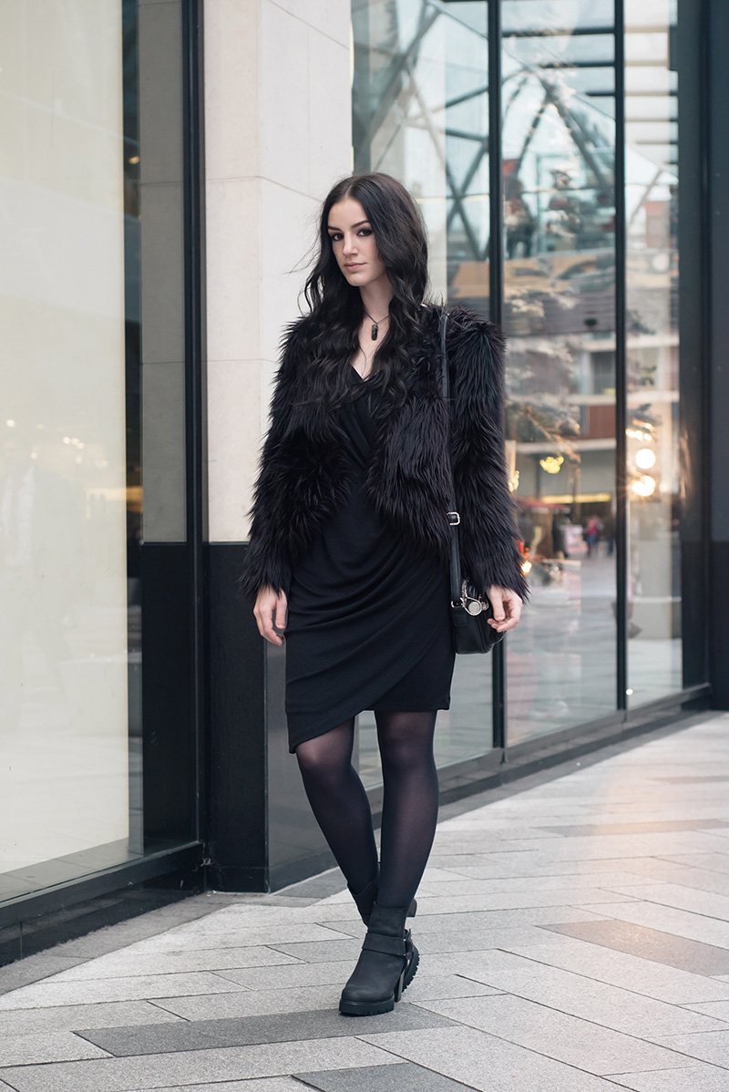 Fashion blogger Stephanie of FAIIINT wearing H&M faux fur cropped jacket, Selected Femme draped glitter dress, New Look stirrup ankle boots, Elemental Luxury necklace, Betty Jackson Black bag. All black everything dark street style outfit.