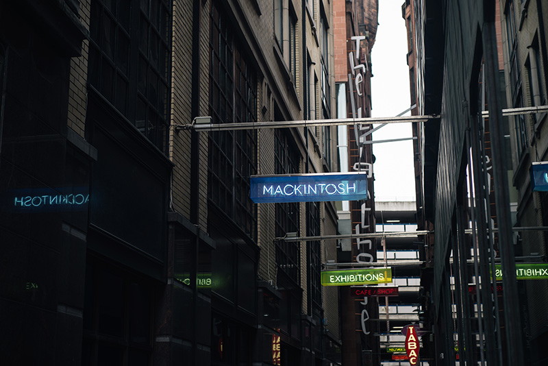 FAIIINT Glasgow architecture side street with neon signs mackintosh
