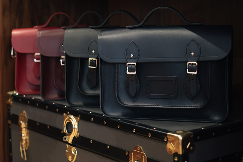 FAIIINT Glasgow Cambridge Satchel Company bags and trunk. Navy blue, black, oxblood red.