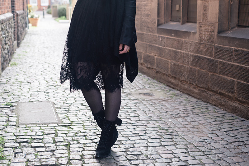 Fashion blogger Stephanie of FAIIINT wearing H&M draped waterfall cardigan, SheIn lace dress, Kurt Geiger saturn lace up boots. All black everything dark street style outfit.