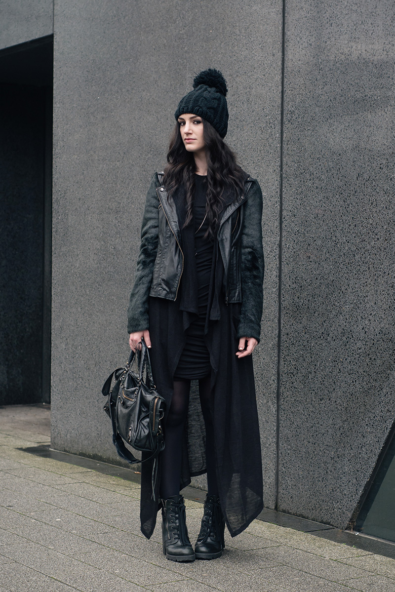 Fashion blogger Stephanie of FAIIINT wearing OASAP Beanie, ASOS faux fur and leather biker jacket, H&M draped maxi cardigan, Vila dress, ASH Poker boots, Balenciaga city bag. All black everything dark street style casual goth outfit.