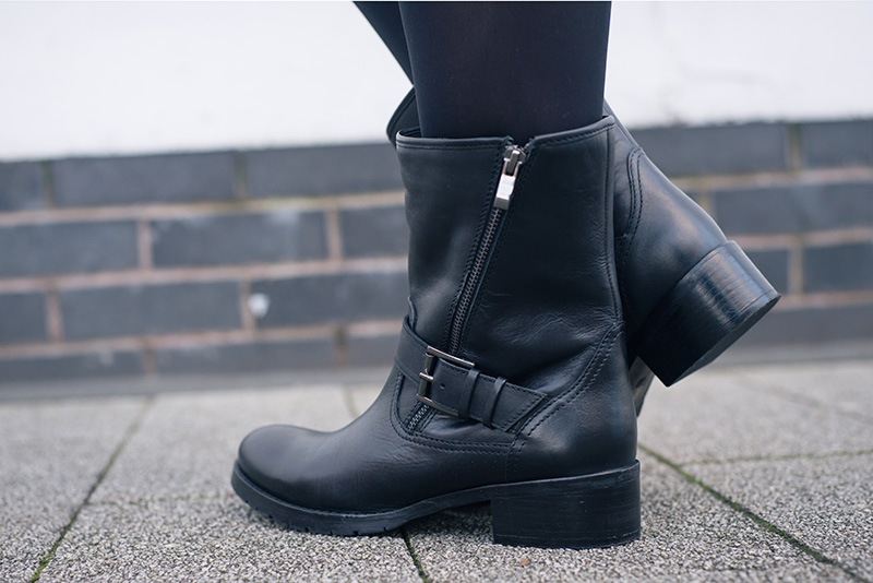 FAIIINT Jones Bootmaker Yazmin black leather biker boots with buckle and zip detail.