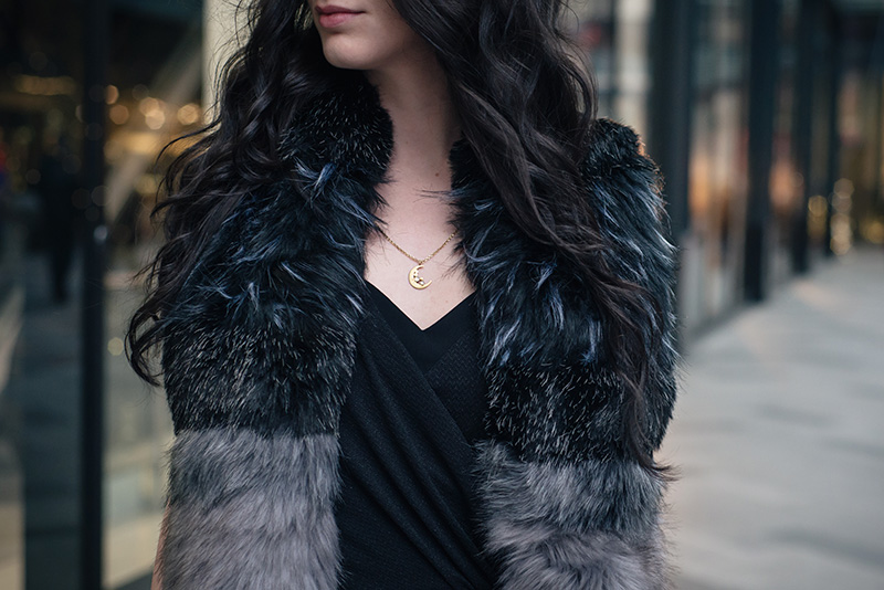 FAIIINT wearing New Look black and grey faux fur stole, Phoebe Jewellery moonstone moon gold necklace, Selected Femme wrap dress. Outfit details.