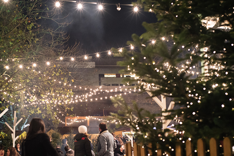 FAIIINT Rekorderlig Cider Lodge Southbank London at Winter Christmas time. Fairy lights outside.