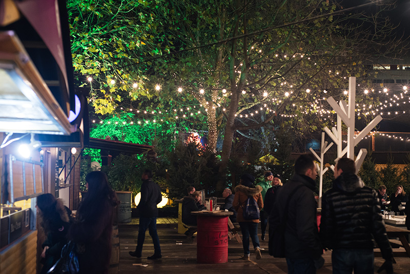 FAIIINT Rekorderlig Cider Lodge Southbank London at Winter Christmas time. Fairy lights outside.