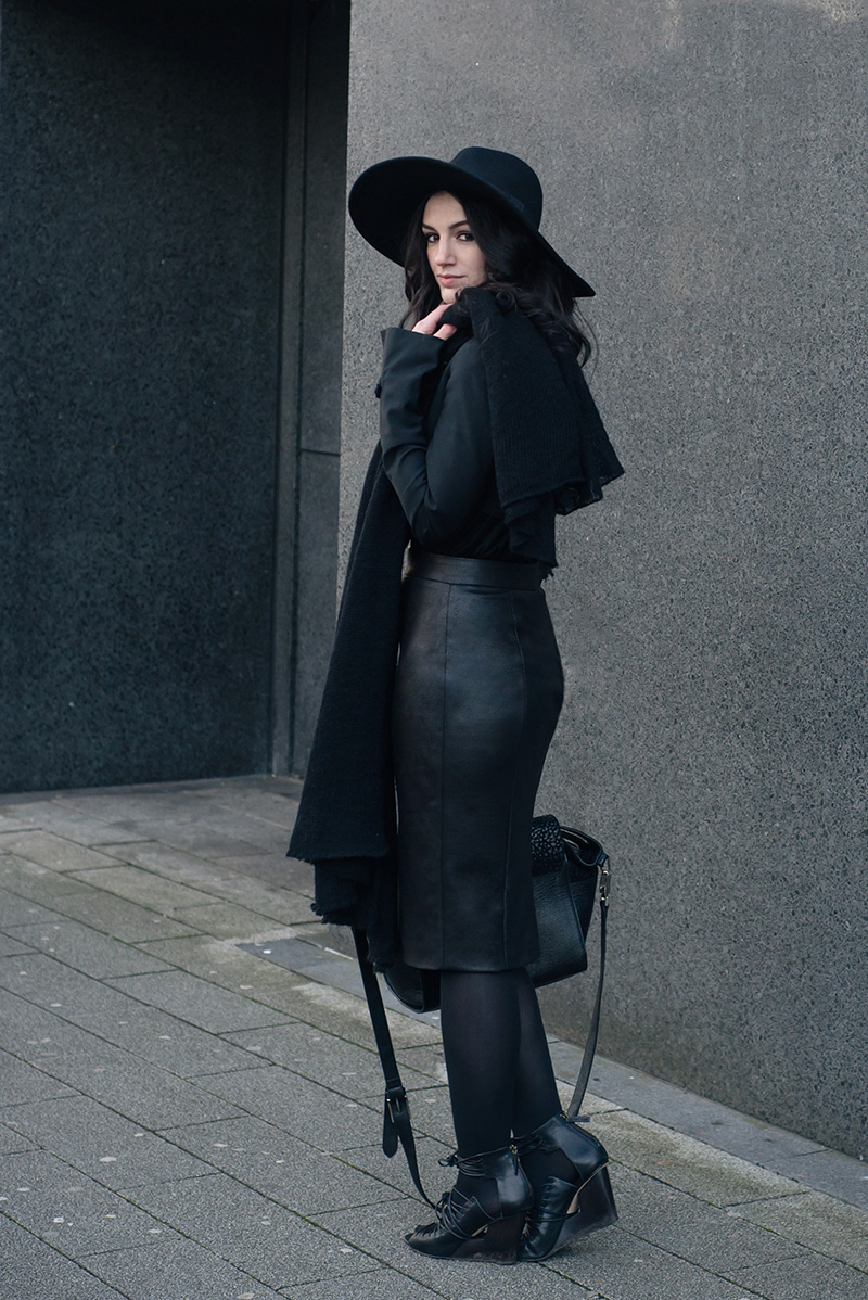 Fashion blogger Stephanie of FAIIINT wearing H&M fedora, Todd Lynn x Topshop cropped jacket, Rita and Phill custom fit Elaine skirt in snake, Skin by Finsk lace up wedges, ASOS draped scarf, Bracher Emden bag. All black everything dark style goth street style winter outfit.