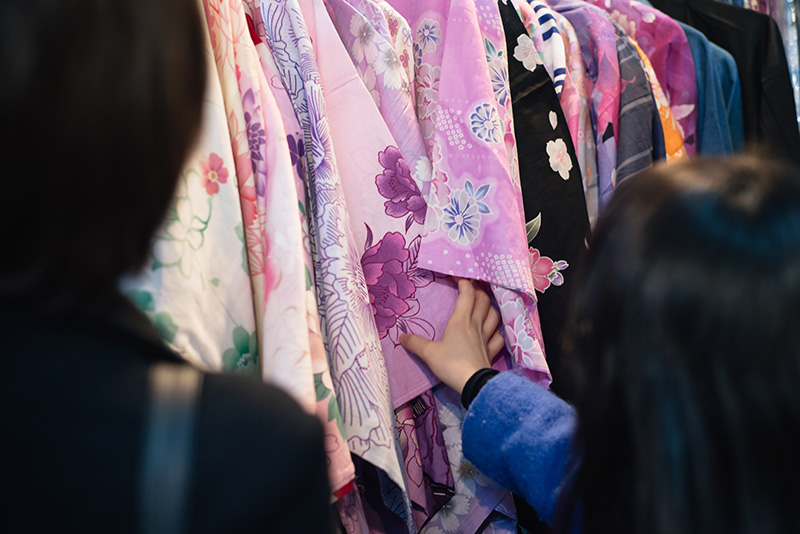 Hyper Japan Christmas Market 2015 at Tobacco Dock London. Guests looking at kimonos.