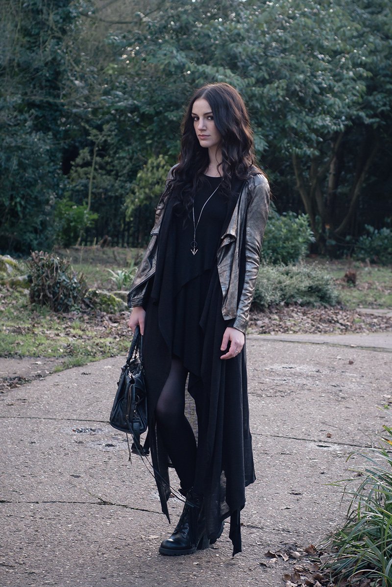 Fashion blogger Stephanie of FAIIINT wearing MuuBaa metallic pewter silver leather drape jacket, H&M hoodie cardigan, FAIIINT splice dress, Hvnter Gvtherer lacustrine necklace, ASH poker boots, Balenciaga city bag. Dark style black layered street style outfit.