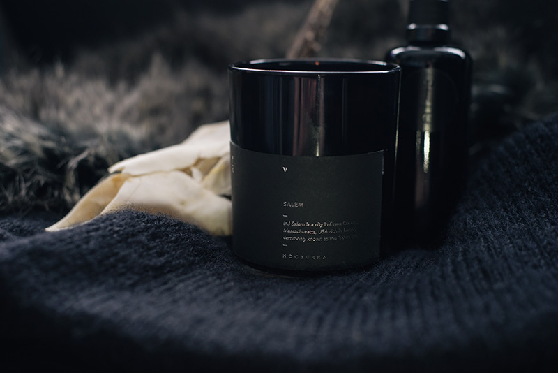 FAIIINT Nocturna 'Salem' candle and Arcana Rose Water Mist. Dark homewear decor still life with deer skull.