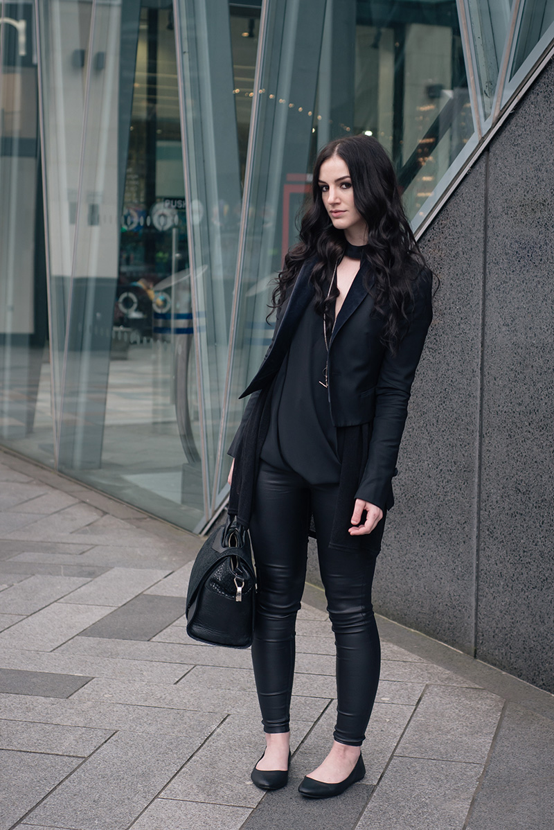 Fashion blogger Stephanie of FAIIINT wearing New Look draped cut out blouse, coated skinny disco jeans, flat leather pumps, Todd Lynn x Topshop tux jacket, Bracher Emden bag. All black everything dark street style outfit.