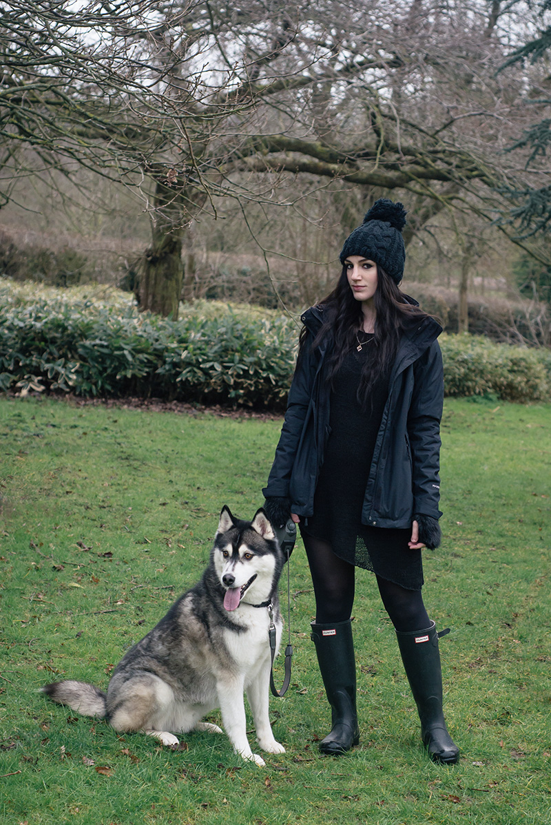 Fashion blogger Stephanie of FAIIINT with husky dog Nico wearing OASAP pom pom beanie, The North Face Evolution TriClimate 3 in 1 jacket, H&M asymmetric jumper, Hunter wellington boots, Topshop faux fur handwarmers. All black everything dark style winter dog walking outfit.