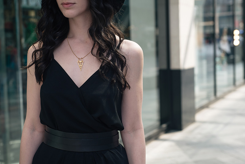 Fashion blogger Stephanie of FAIIINT wearing ASOS wrap cami, Pieces thick leather waist belt, RockLove chevron sacred geometry gold necklace. All black everything outfit details.