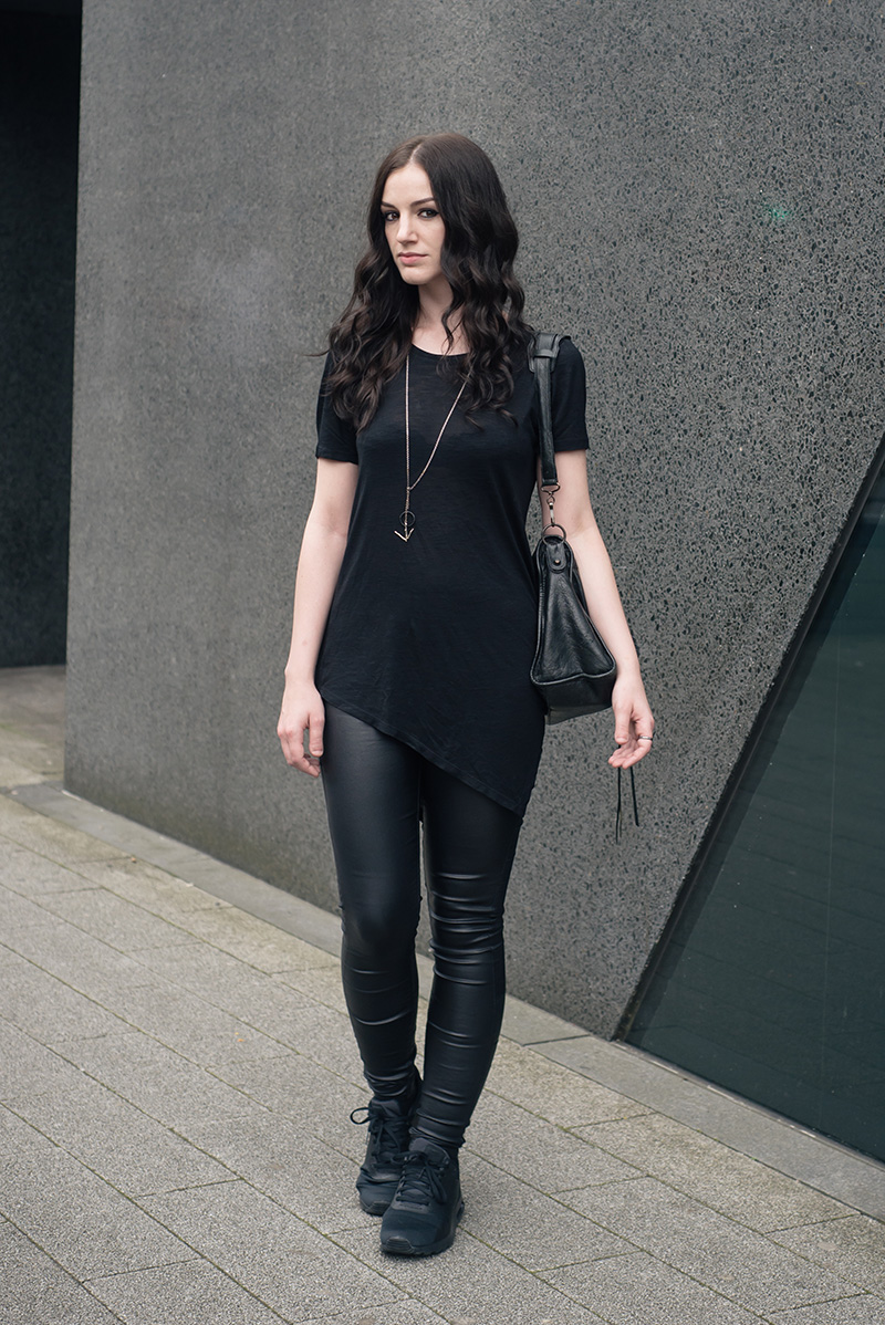 Fashion blogger Stephanie of FAIIINT wearing H&M asymmetric tee shirt, New Look coated jeans, Nike triple black Air Max Tavas trainers, Hvnter Gatherer Lacustrine necklace, Balenciaga city bag. All black everything casual goth dark street style outfit..