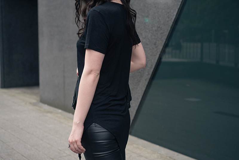 Fashion blogger Stephanie of FAIIINT wearing H&M asymmetric tee shirt, New Look coated jeans. All black everything casual goth dark street style outfit..