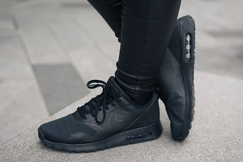 FAIIINT wearing Nike Air Max Tavas triple black trainers. All black everything casual details.