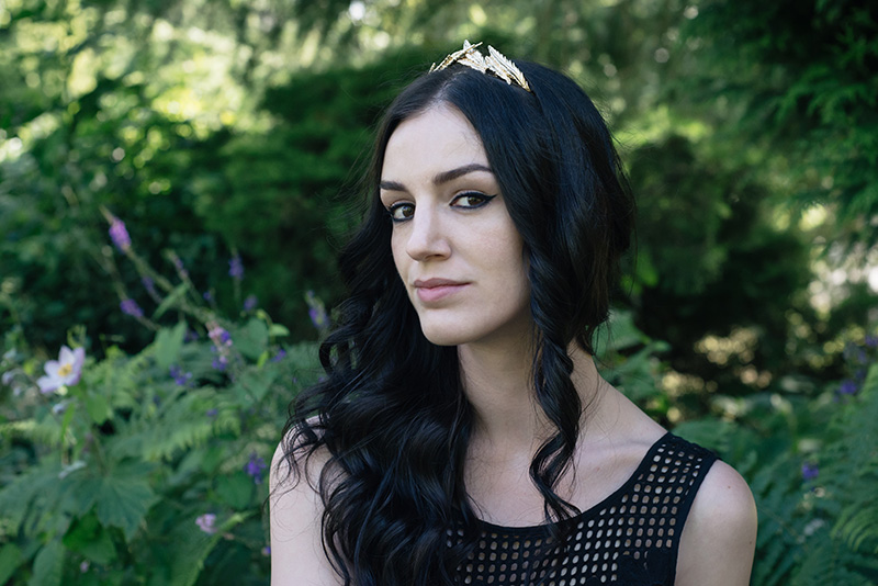 Portrait of fashion blogger Stephanie of FAIIINT wearing ASOSgold leaf crown headband. All black wedding guest outfit details.