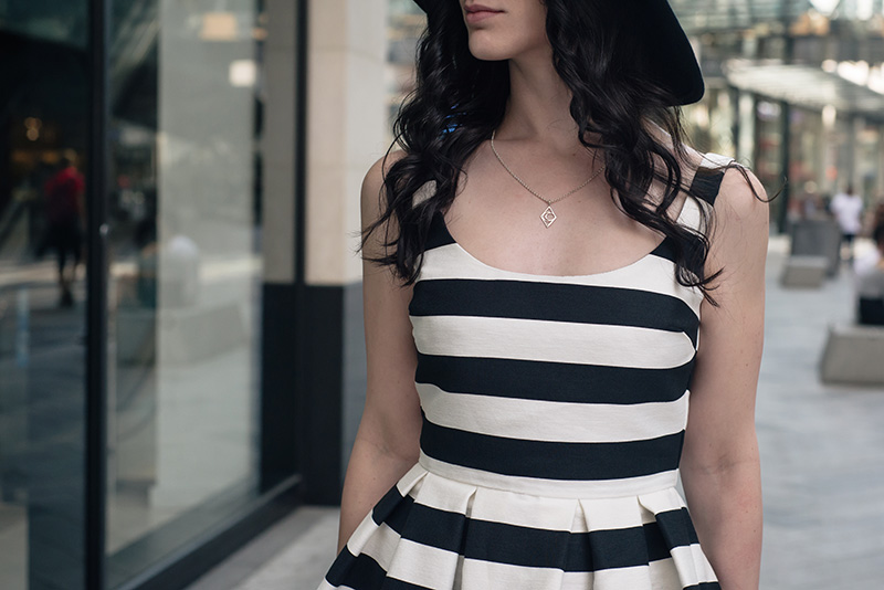 Fashion blogger Stephanie of FAIIINT wearing Warehouse black and white bold striped 50s prom dress, Bloody Mary Metal tribal moon silver necklace. Outfit details.